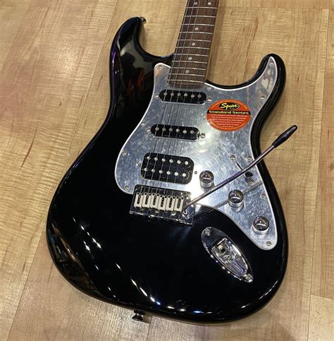 black guitar with black pickguard